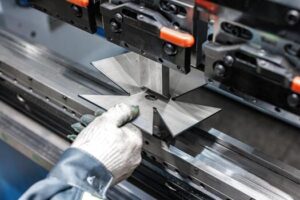Precision In Motion A Skilled Operator Shapes Metal With State Of The Art Bending Machinery Transforming Raw Sheets Into Custom Creations Photo 300x200